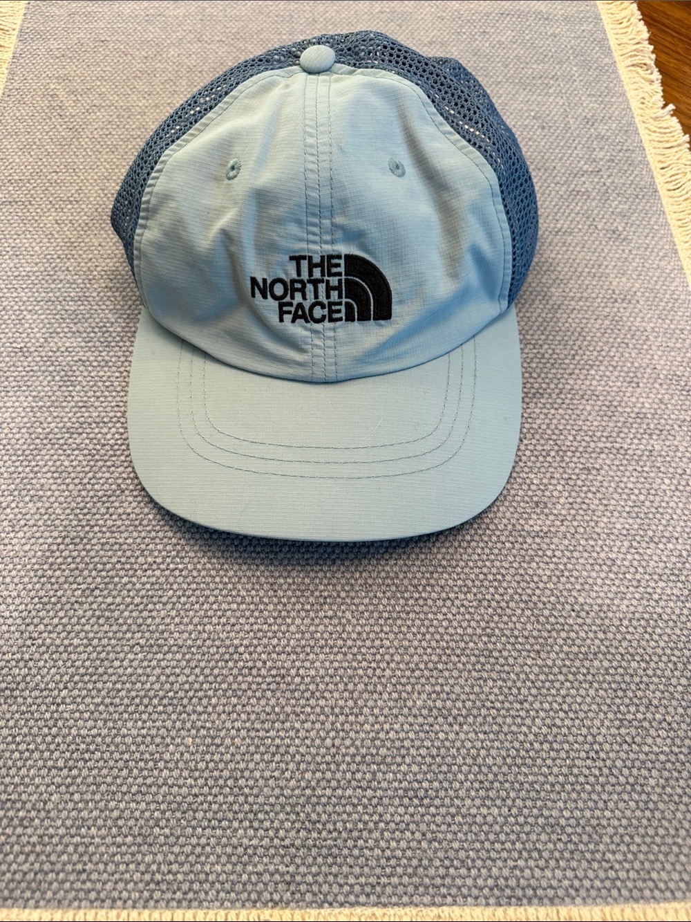 The North Face Light Blue Mesh Back Cap with Black Logo. Never worn.